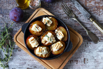 Baked plums with feta cheese. French cuisine Healthy organic food.