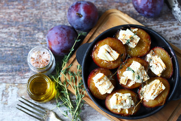 Baked plums with feta cheese. French cuisine Healthy organic food.