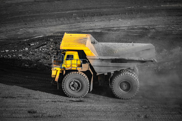 Obraz premium Big yellow mining truck empty body for anthracite. Open pit mine, extractive industry for coal