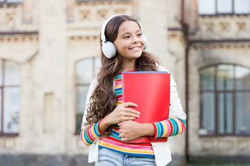Do you speak english. Happy child listening to English audio course. Little girl learning English...