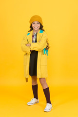 Fototapeta na wymiar Schoolgirl fancy child. Aesthetics of clothes. Fall outfit. Modern teen outfit concept. Outfit for daily school life. Feeling cool and stylish. Fall fashion. Little girl wearing stylish hat and coat
