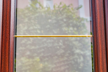 Fragment of a new plastic window with lamination