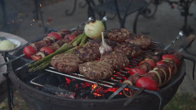 Outdoor grill with beef and vegatables in slow motion. 