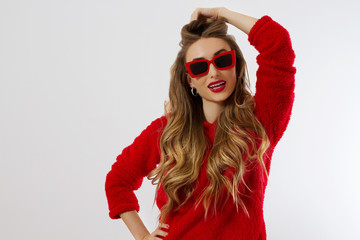 Happy, shock, excited woman face closeup. Girl in bright red hoodie autumn clothes red sunglasses isolated. white background, copy space. Beautiful female surprised, cheerful. model Fun time