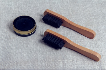 Shoe Care Kit: Brushes and paste for cleaning shoes.