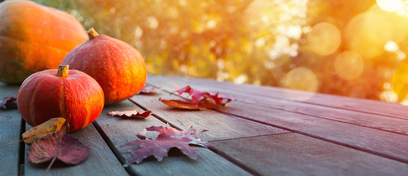 Autumn pumpkin on wooden table; thanksgiving holiday party background,