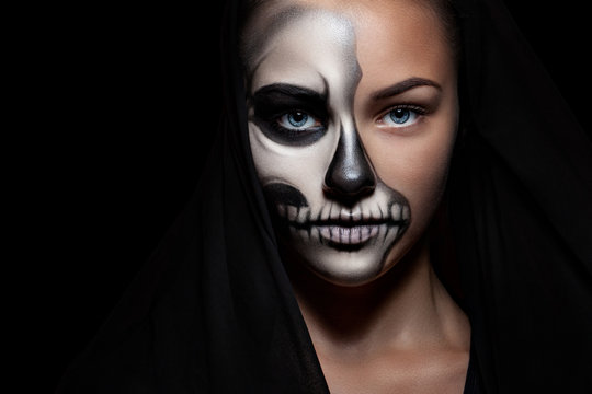 Halloween. Portrait of young beautiful girl with make-up skeleton on her face