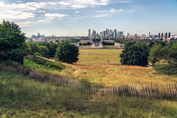 Fototapeta na wymiar London panorama seen from Greenwich park viewpoint. Symbolic Broken fence in the foreground