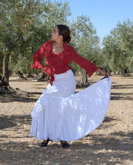 Girl in a flamenco position in an olive grove