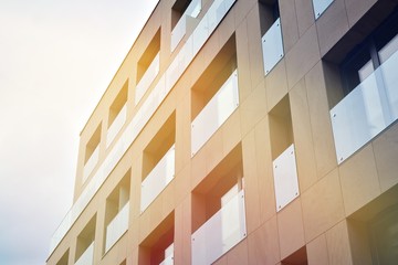 Modern apartment buildings on a sunny day with a blue sky. Facade of a modern apartment building.Glass surface with sunlight.