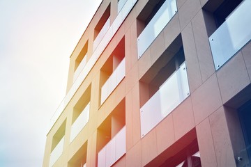 Modern apartment buildings on a sunny day with a blue sky. Facade of a modern apartment building.Glass surface with sunlight.