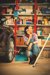 mechanic in an auto repair shop talking on mobile