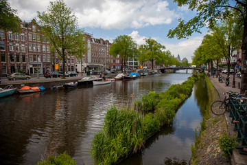 Fototapeta na wymiar Embankment of Amstel canal in Amsterdam at summer day, Netherlands