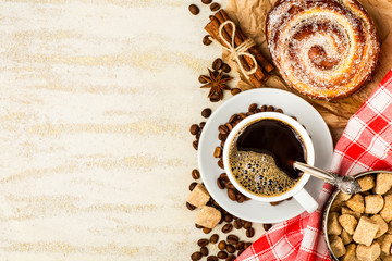 Coffee cup with roasted beans on stone background.Cup of espresso and a small Breakfast croissants, Top view with copy space for your text