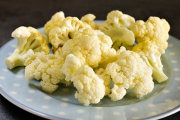 cauliflower close-up on blue plate with gray background