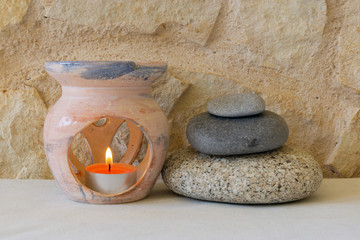 the four elements: fire, earth, water and air. Incense burner censer and composition of stones with a ball containing water and air bubblesin front of white rural background. Selective focus on fire