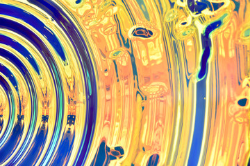 surface with a radial diverging relief similar to waves of blue and gold color fragment, shiny, abstraction