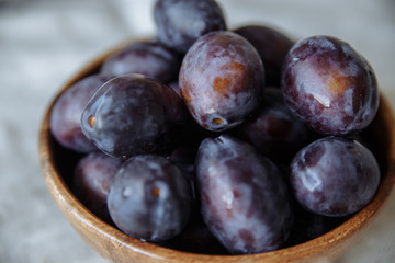 Plums macro in wood plate