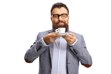 Bearded man smelling a cup of espresso coffee