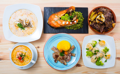 Dishes of traditional Norwegian cuisine with lamb rib, seafood and  vegetables