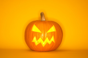 Halloween pumpkin head jack isolated on yellow background