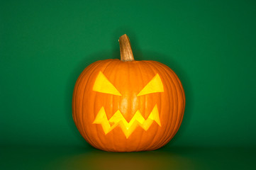 Halloween pumpkin head jack isolated on green background
