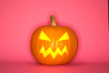 Halloween pumpkin head jack isolated on pink background