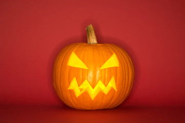 Halloween pumpkin head jack isolated on red background