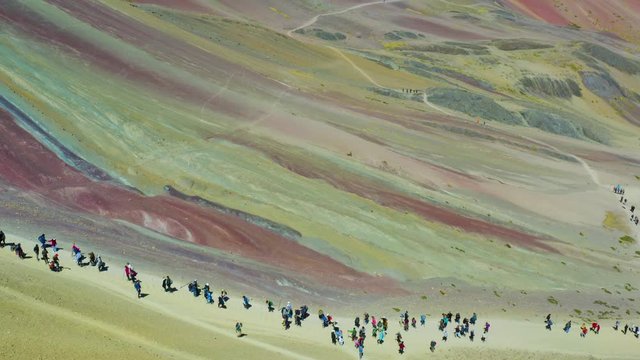 Aerial landscape of people hiking climbing Rainbow Mountain (or Monta&ntilde;a de los Siete Colores) at  Vinicunca Valley. Mountain full of yellow, red, green and different colours. Cusco Region, Peru