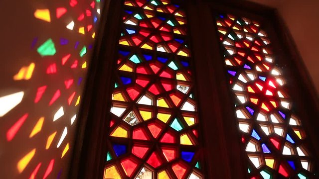 Beautiful stained glass windows with sunlight in the background