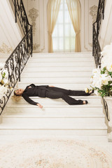Crime scene. Business woman shot to death on the luxury stairs ..