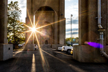 sun burst under bridge parking lot