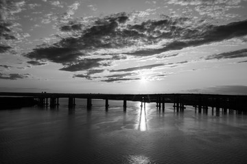 sunset over bay and bridge silhouette