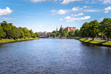 Fototapeta premium Beautiful view of river Ness flowing through Inverness, Scotland, on a clear summer day