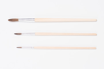 three paint brushes