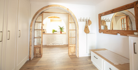 Big wooden handmade mirror in hallway.