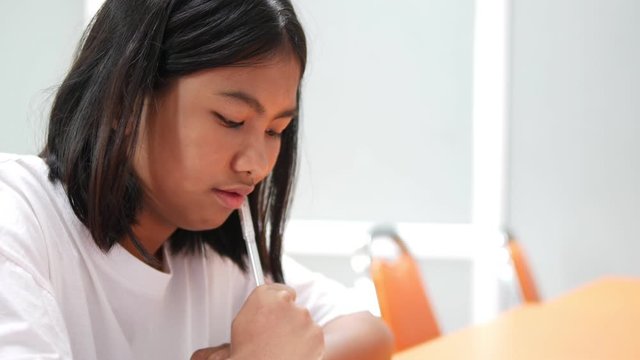 Asian high school student girl is studying in classroom