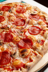 Close up of hot pepperoni pizza with melted cheese and mushrooms