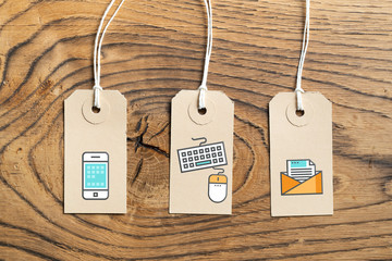 Hangtags on wooden background with contact option icons 