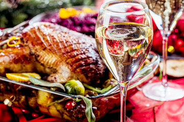 Christmas themed dinner table with christmas duck and champagner  