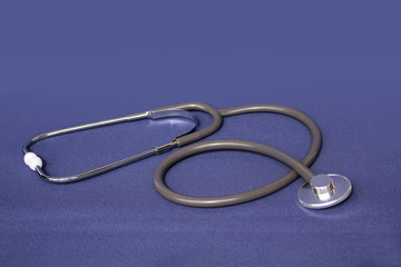 medical device for listening stethoscope on a blue background, medical research and healthcare concept, top view, close-up, copy space