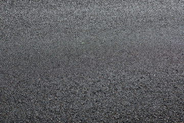 tarmac road texture of asphalt road surface with copy space close up.