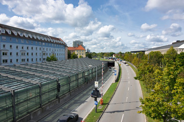 The main street 'Mittlerer Ring' in Munich, Schwabing, just before the confluence with the traffic tunnel 'Petueltunnel'. In the background the intersection with the Leopoldstraße.