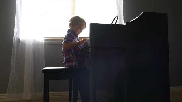 Child practices playing the piano