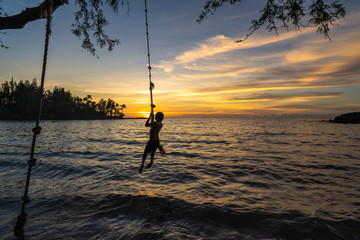 Kid playing by the Ocean