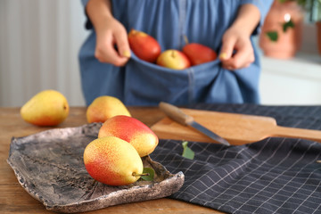 Plate with tasty fresh pears on table