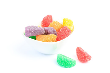 Colorful Fruit-flavored Candy Gels in White Bowl on white BG with Copy Spacee