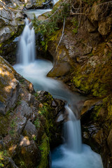 Fototapeta premium Water Streams Through Carved Rocks Above Christine Falls