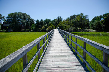 Naklejka na ściany i meble Wooden walkway over the marsh at Oak Island North Carolina