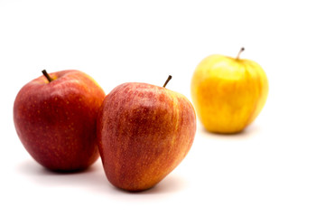 red apples together with the yellow apple seperated